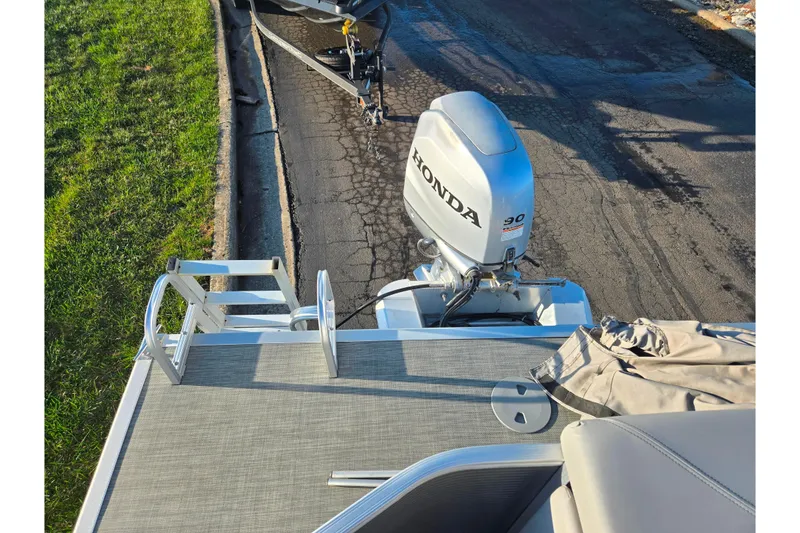 Slide: The Image of 2021 Bennington S 20 L-Bench pontoon boat with Honda outboard motor. - 17