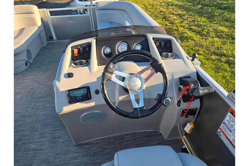 Slide: The Image of 2021 Bennington S 20 L-Bench boat dashboard with steering wheel and controls. - 21