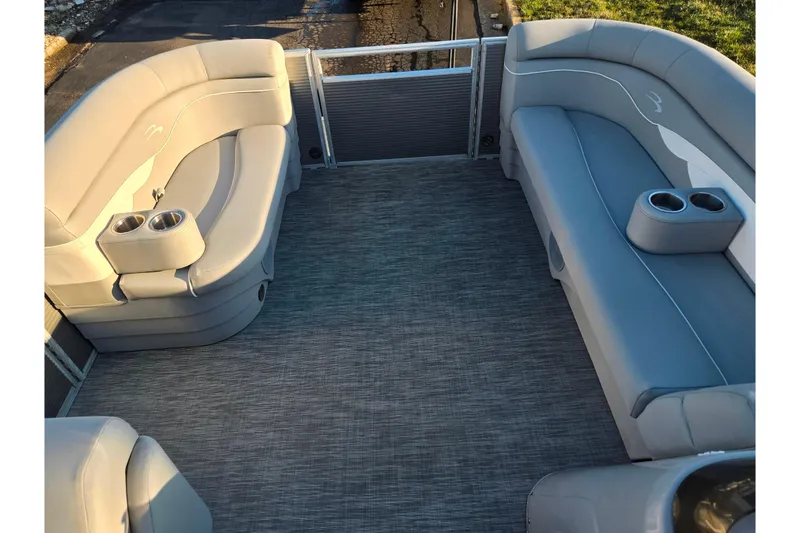 Slide: The Image of 2021 Bennington S 20 L-Bench pontoon boat interior with gray seating and cup holders. - 23