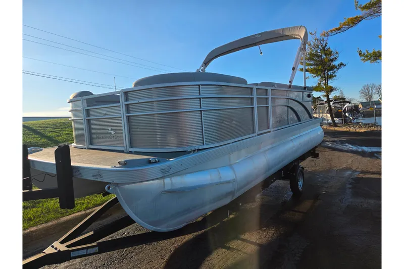 Slide: The Image of 2021 Bennington S 20 L-Bench pontoon boat on trailer, sunny day. - 5