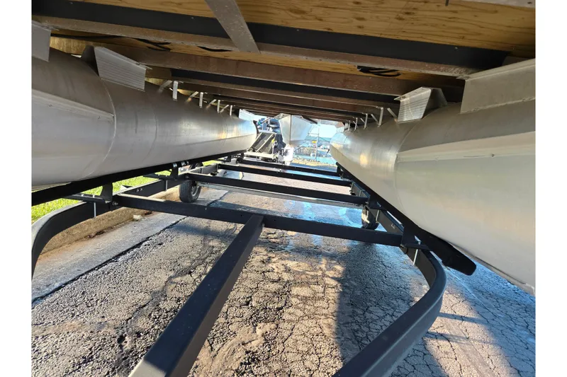 Slide: The Image of Underneath view of a 2021 Bennington S 20 L-Bench pontoon boat on a trailer. - 7