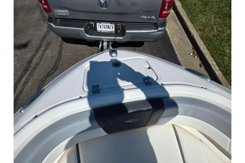 Slide: The Image of 2024 Chaparral 21 SSi boat hitched to a truck, ready for transport. - 11