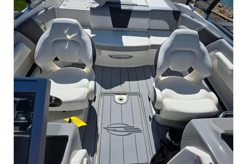 Slide: The Image of 2024 Chaparral 21 SSi boat interior with white seating and sleek design. - 23
