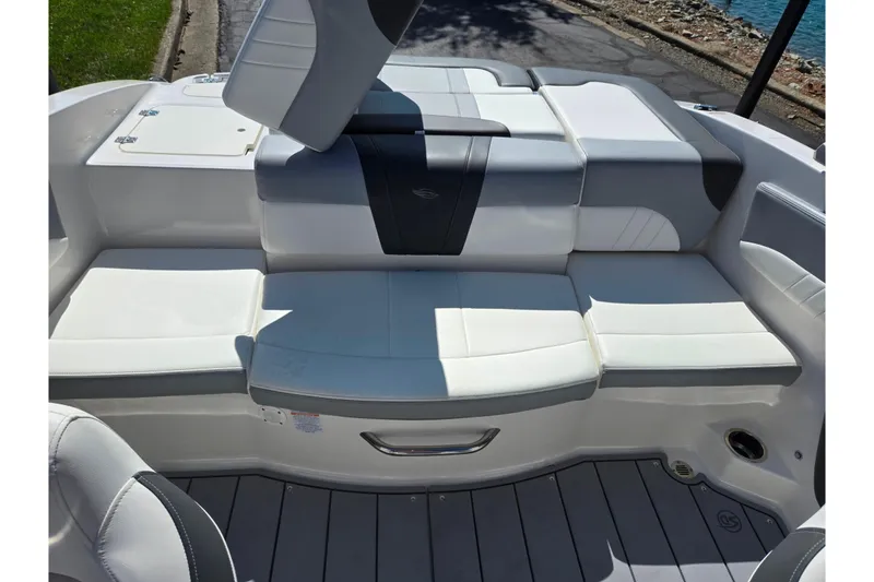 Slide: The Image of 2024 Chaparral 21 SSi boat interior with white cushioned seating and sleek design. - 24