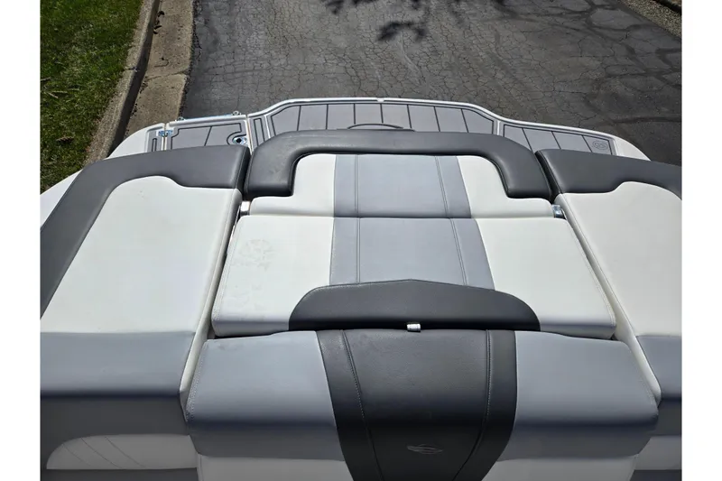 Slide: The Image of 2024 Chaparral 21 SSi boat's rear seating area with gray and white upholstery. - 25