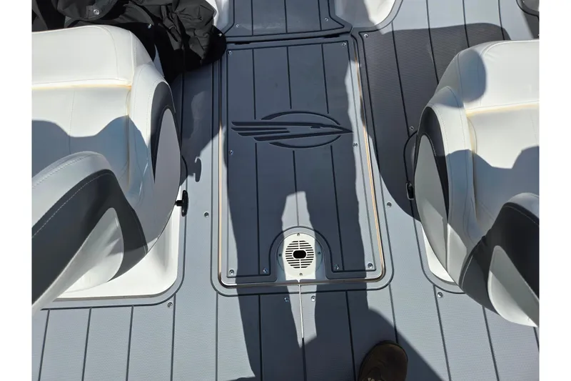 Slide: The Image of 2024 Chaparral 21 SSi boat interior with white and gray seating and flooring. - 4