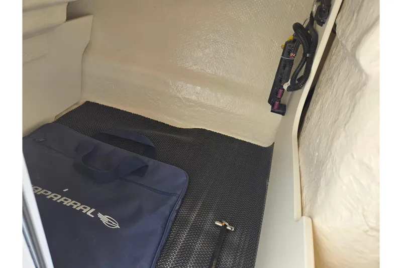 Slide: The Image of Interior storage compartment of 2024 Chaparral 21 SSi boat with Chaparral-branded bag. - 8
