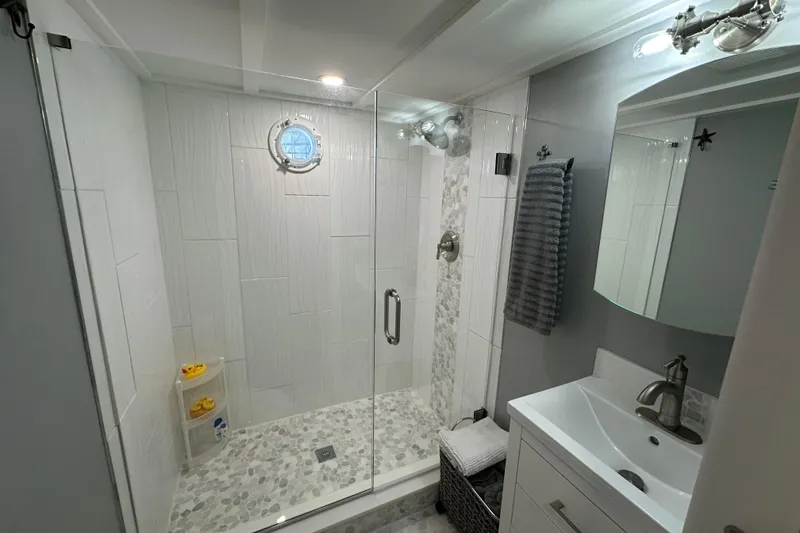 Slide: The Image of Modern bathroom in 1974 Lazy Days 14x56 model with glass shower and sleek fixtures. - 11