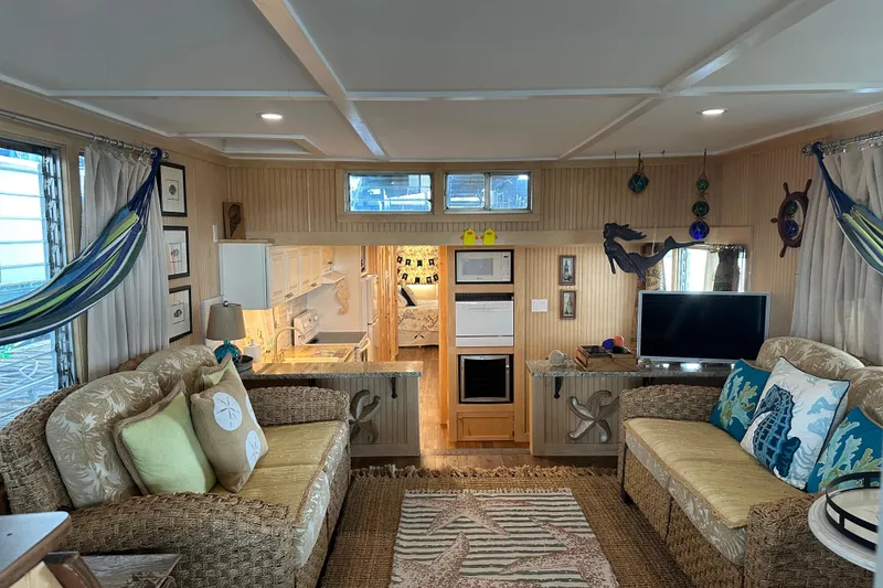 Slide: The Image of Interior of a 1974 Lazy Days 14x56 houseboat with cozy seating and nautical decor. - 2