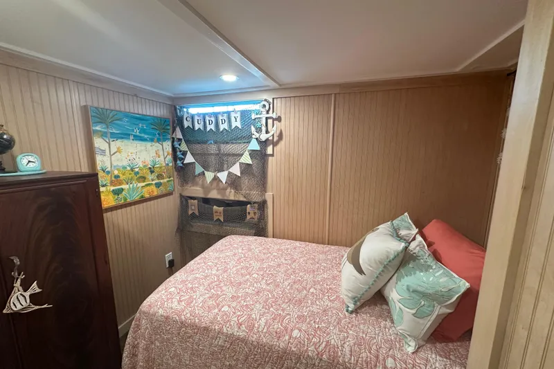 Slide: The Image of Cozy bedroom in a 1974 Lazy Days 14x56 houseboat with nautical decor. - 6