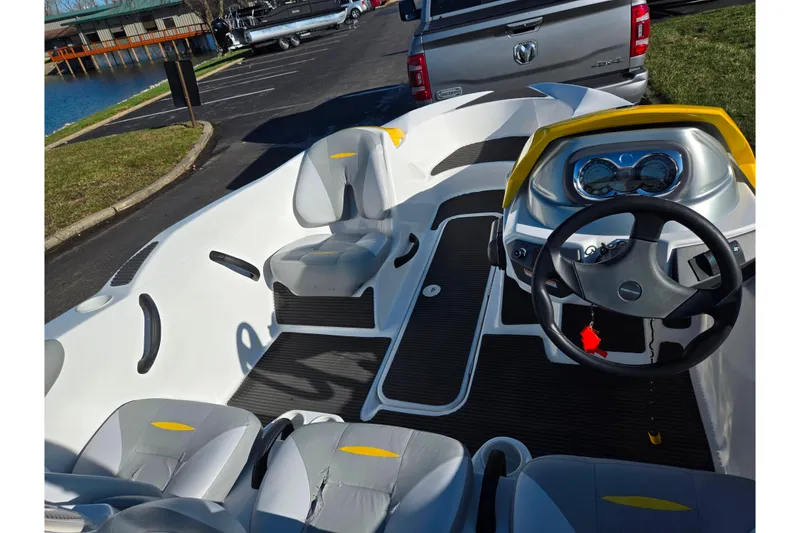 Slide: The Image of 2008 Sea-Doo 150 Speedster boat interior with steering wheel and seating, parked near water. - 11