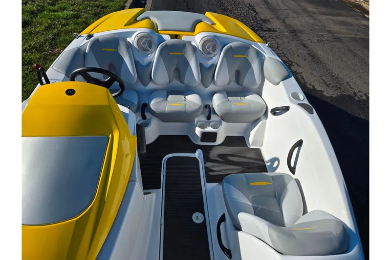 Slide: The Image of 2008 Sea-Doo 150 Speedster boat interior with yellow and gray seating. - 19