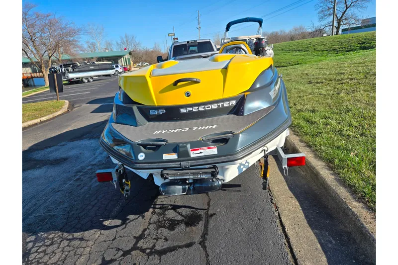 Slide: The Image of 2008 Sea-Doo 150 Speedster boat on trailer, parked outdoors. - 2