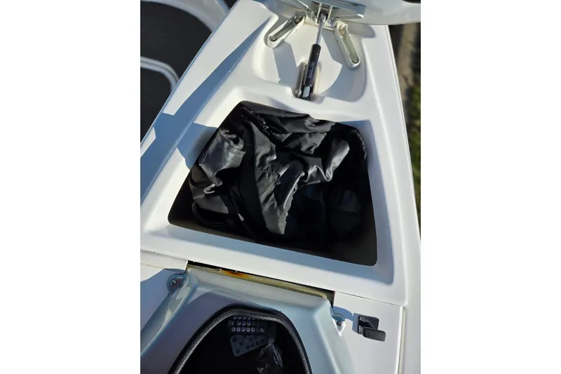 Slide: The Image of Storage compartment of a 2008 Sea-Doo 150 Speedster boat, featuring a black bag. - 23
