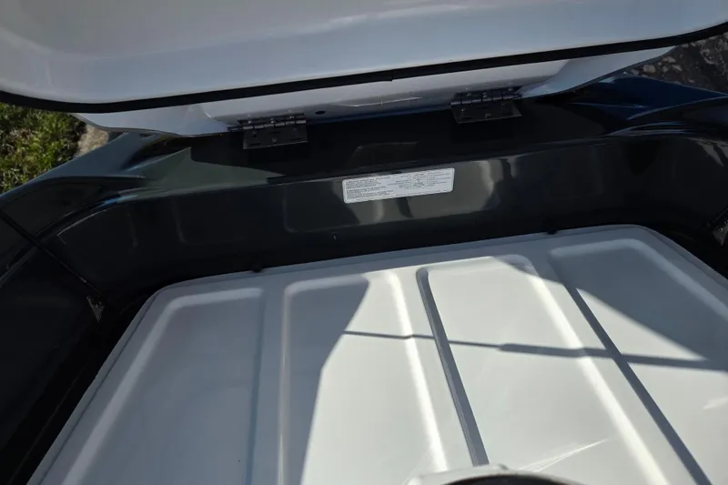 Slide: The Image of Open storage compartment of 2008 Sea-Doo 150 Speedster boat, showing interior details. - 24