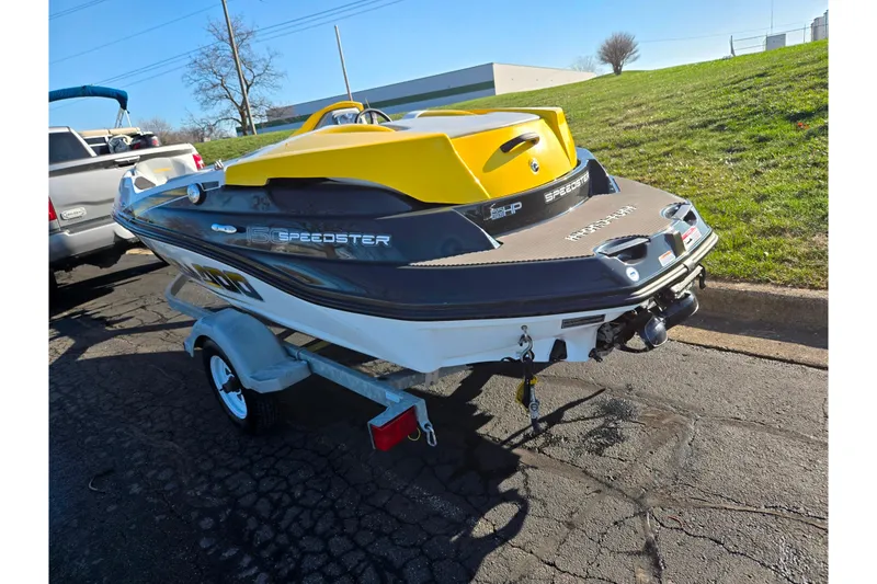 Slide: The Image of 2008 Sea-Doo 150 Speedster boat on trailer, parked on asphalt near grassy area. - 3