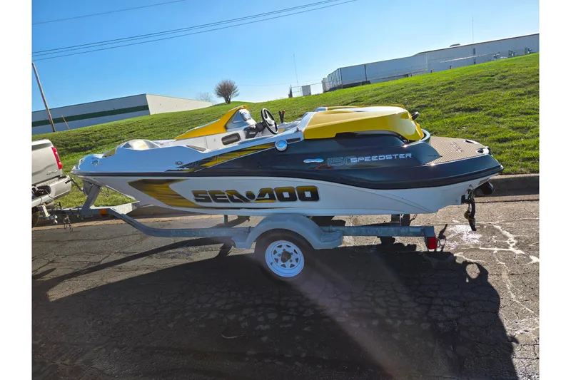 Slide: The Image of 2008 Sea-Doo 150 Speedster boat on trailer, parked outdoors in sunny setting. - 4
