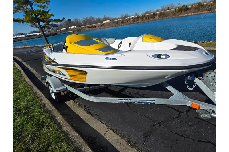 Slide: The Image of 2008 Sea-Doo 150 Speedster boat on trailer by a lake. - 9