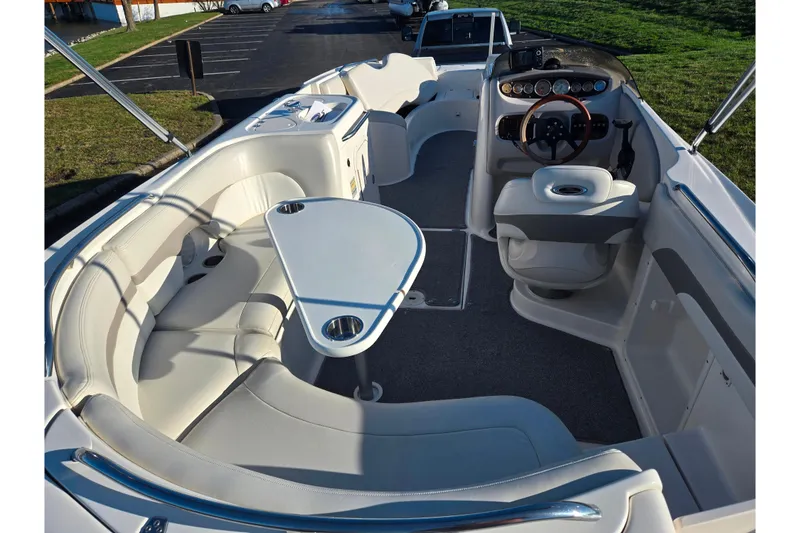 Slide: The Image of 2005 Chaparral Sunesta 232 boat interior with seating and steering console. - 10