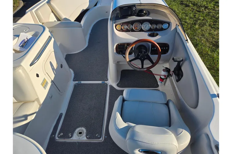 Slide: The Image of 2005 Chaparral Sunesta 232 boat interior with steering wheel and dashboard controls. - 11