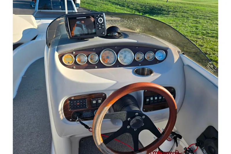 Slide: The Image of 2005 Chaparral Sunesta 232 dashboard with steering wheel and navigation instruments. - 12