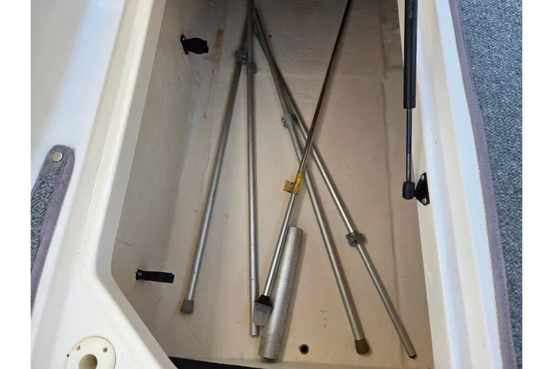 Slide: The Image of Storage compartment with metal rods in a 2005 Chaparral Sunesta 232 boat. - 13