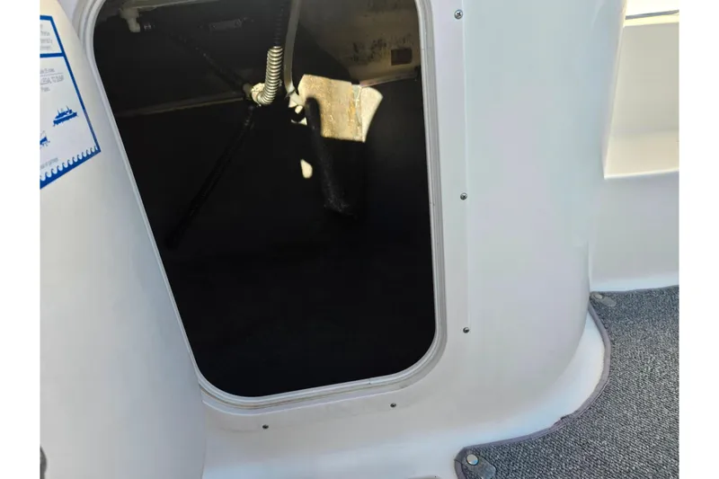 Slide: The Image of Open storage compartment on a 2005 Chaparral Sunesta 232 boat. - 15