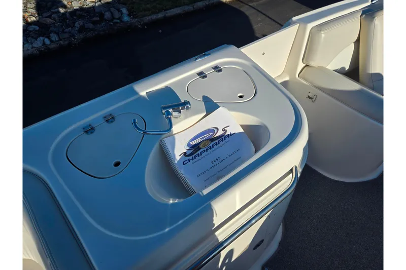 Slide: The Image of 2005 Chaparral Sunesta 232 boat interior with manual on console. - 16