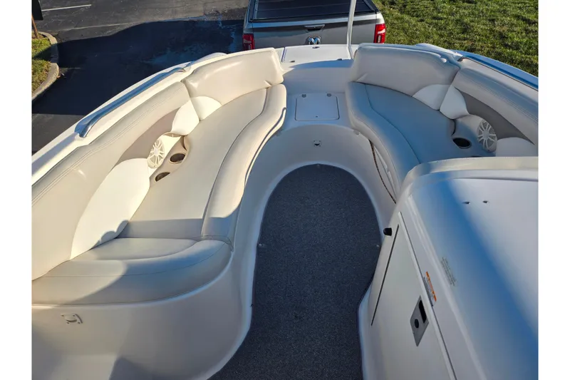 Slide: The Image of 2005 Chaparral Sunesta 232 boat interior with white seating and carpeted floor. - 18