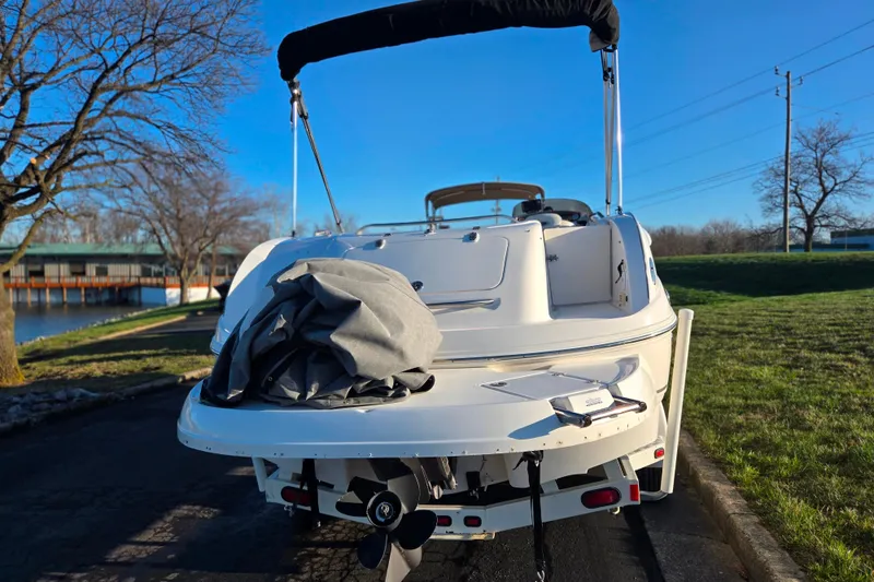 Slide: The Image of 2005 Chaparral Sunesta 232 boat parked on a sunny day near a lake. - 2