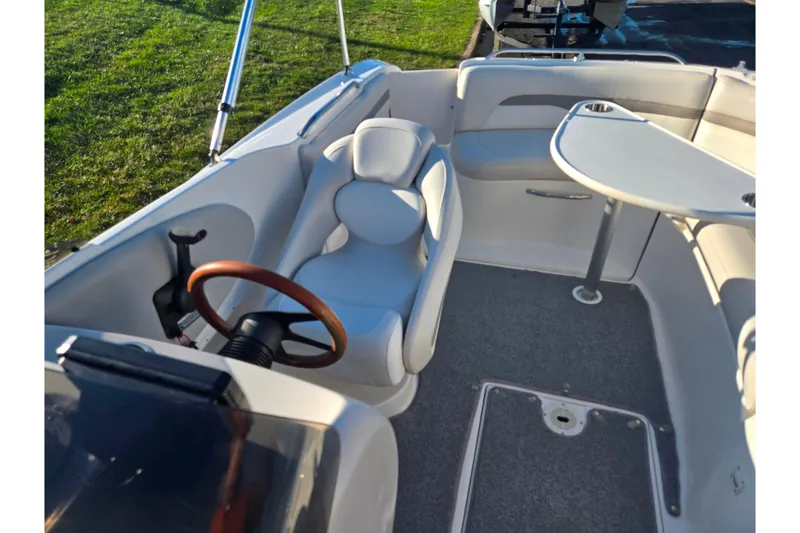 Slide: The Image of 2005 Chaparral Sunesta 232 boat interior with steering wheel and seating area. - 23