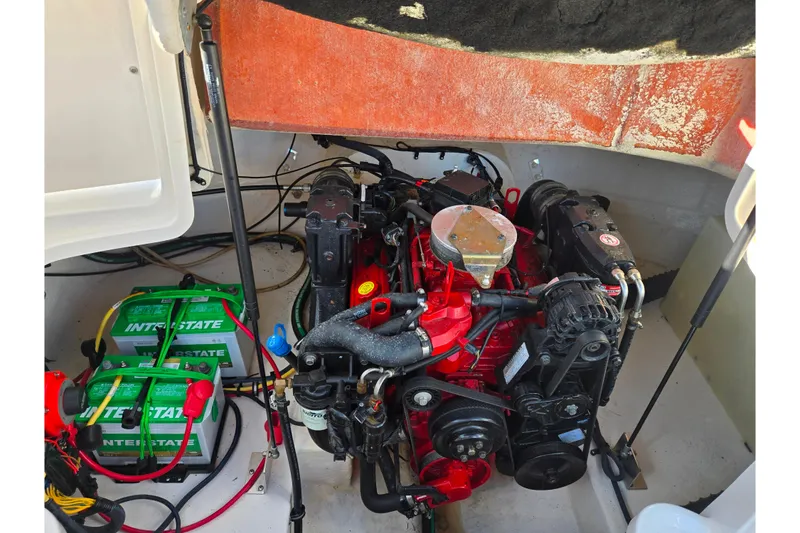 Slide: The Image of Engine compartment of a 2005 Chaparral Sunesta 232 with visible batteries and components. - 25