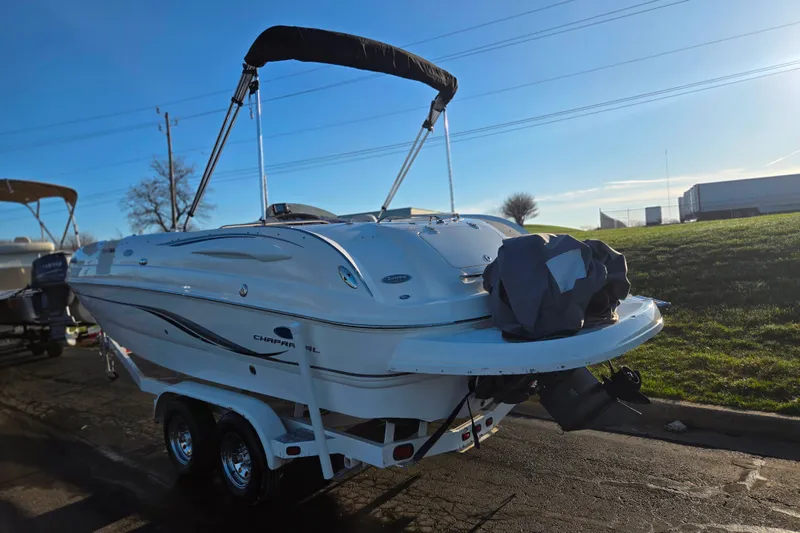 Slide: The Image of 2005 Chaparral Sunesta 232 boat on trailer, parked outdoors under clear sky. - 3