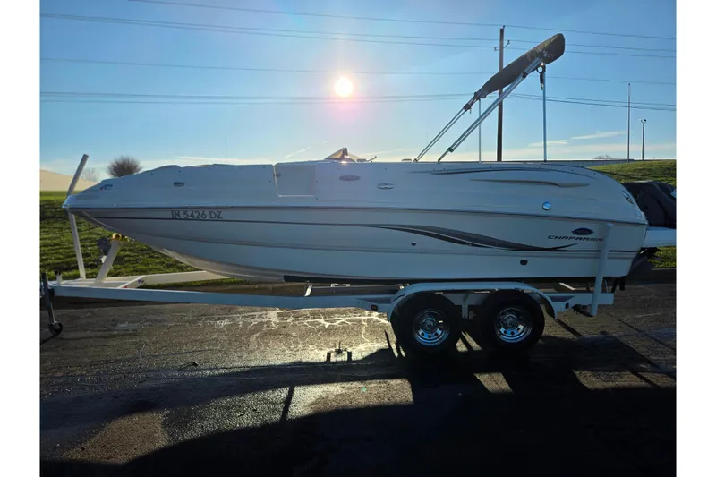 Slide: The Image of 2005 Chaparral Sunesta 232 boat on trailer, parked outdoors under bright sunlight. - 4