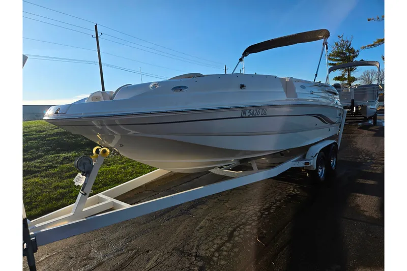 Slide: The Image of 2005 Chaparral Sunesta 232 boat on trailer, parked outdoors under clear sky. - 5
