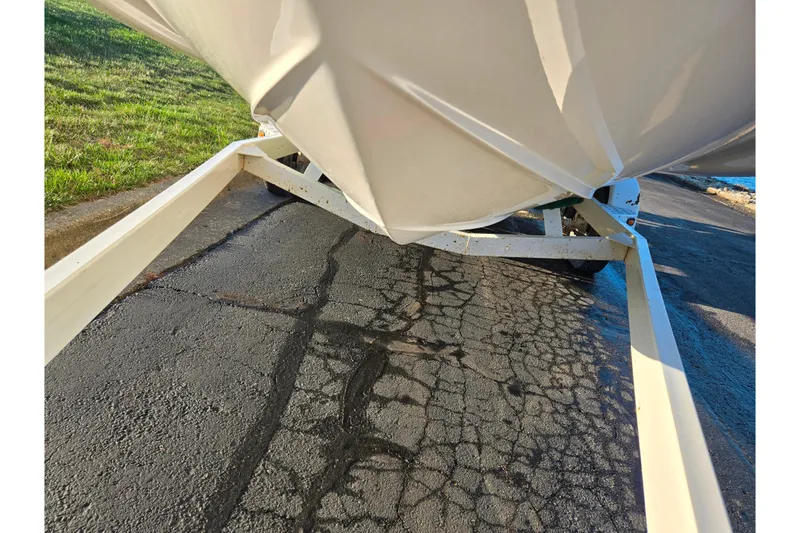 Slide: The Image of 2005 Chaparral Sunesta 232 boat on trailer, parked on cracked asphalt. - 7