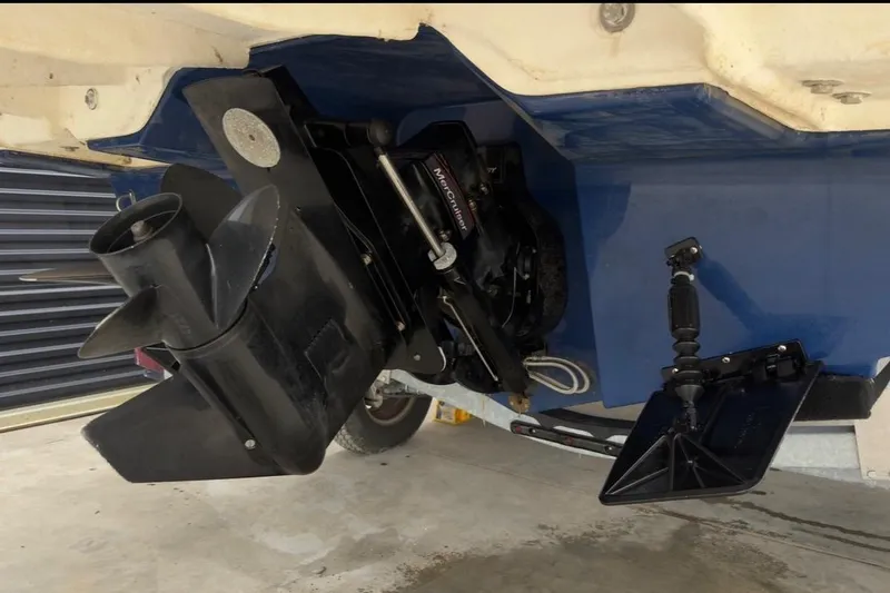 Slide: The Image of Bayliner DX 2250 2022 boat stern drive and propeller in a garage setting. - 1