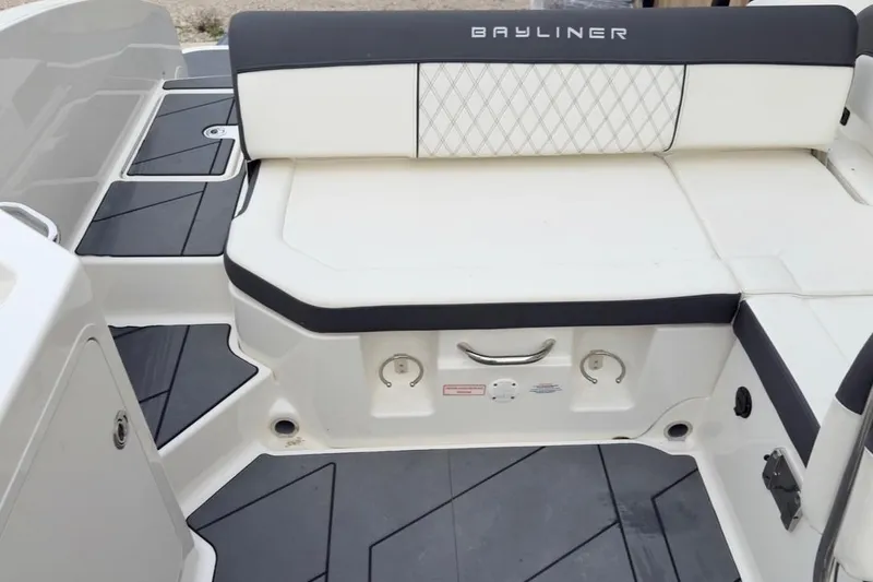 Slide: The Image of 2022 Bayliner DX 2250 boat interior with cushioned seating and modern design. - 3