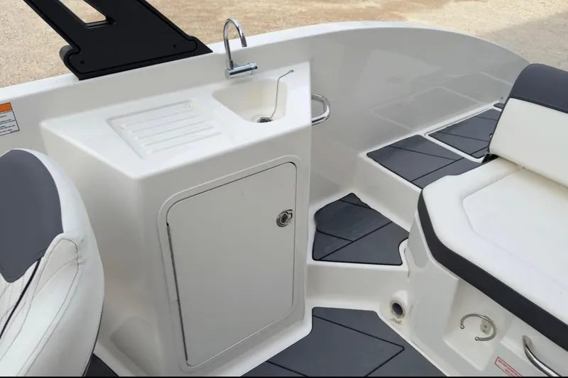 Slide: The Image of Interior of 2022 Bayliner DX 2250 boat with seating and sink area. - 4