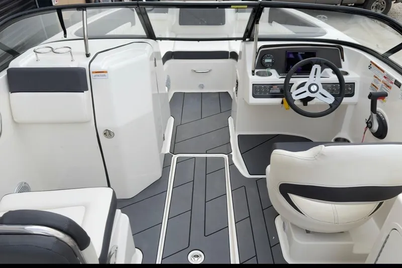 Slide: The Image of 2022 Bayliner DX 2250 boat interior with modern helm and seating. - 6