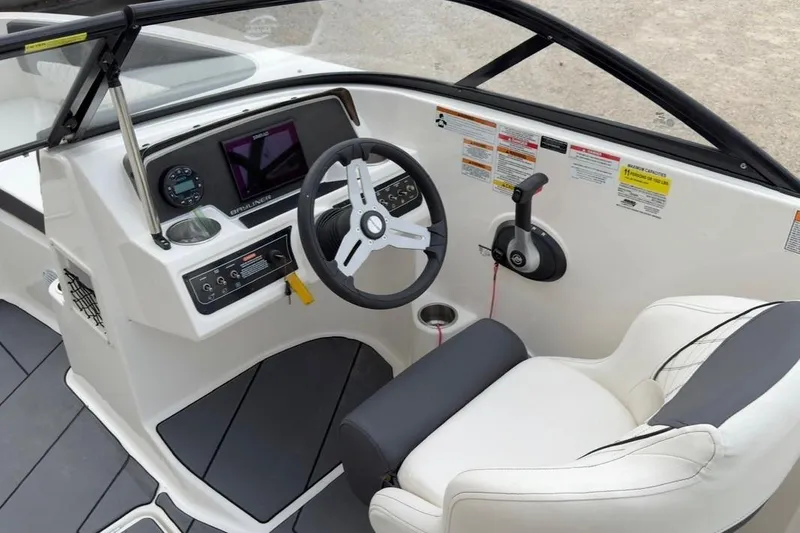 Slide: The Image of Interior cockpit of 2022 Bayliner DX 2250 boat with steering wheel and controls. - 7