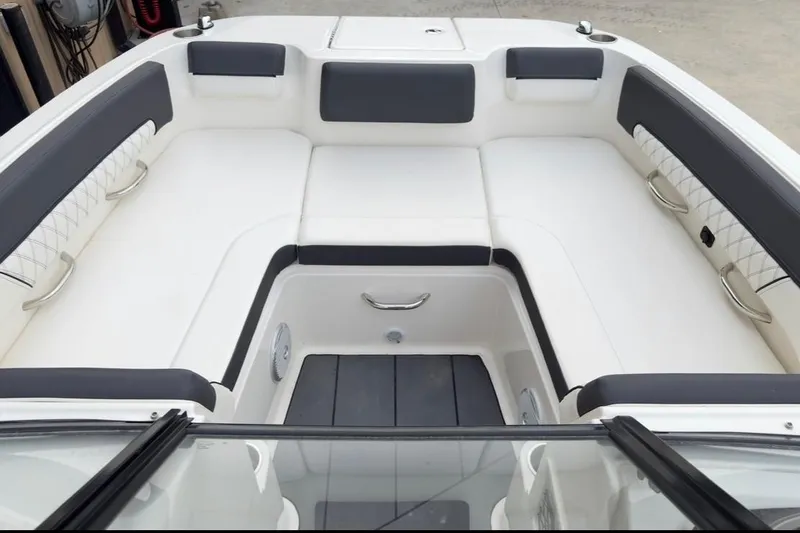 Slide: The Image of 2022 Bayliner DX 2250 boat interior with white and gray seating arrangement. - 8