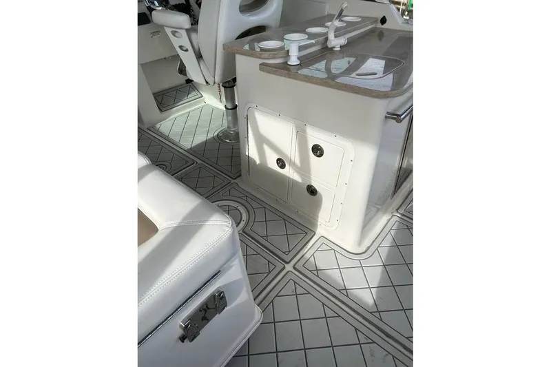 Slide: The Image of Interior of a 2016 Sailfish 275 DC boat, featuring seating and storage compartments. - 10