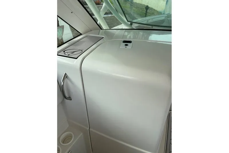 Slide: The Image of Interior view of a 2016 Sailfish 275 DC boat, featuring a sleek dashboard design. - 14