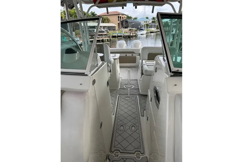 Slide: The Image of 2016 Sailfish 275 DC boat interior with seating and open deck view. - 16