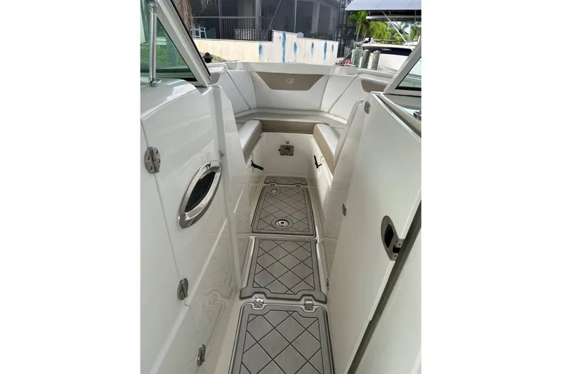 Slide: The Image of 2016 Sailfish 275 DC boat interior with cushioned seating and non-slip flooring. - 18