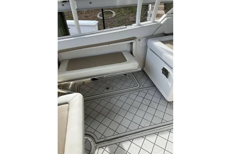 Slide: The Image of Interior of 2016 Sailfish 275 DC boat with cushioned seating and patterned flooring. - 5