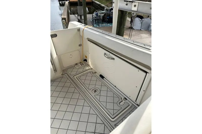 Slide: The Image of 2016 Sailfish 275 DC boat deck with storage compartment and patterned flooring. - 6