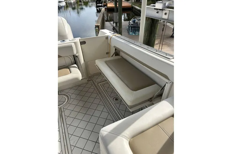 Slide: The Image of 2016 Sailfish 275 DC boat interior with cushioned seating and patterned flooring. - 7