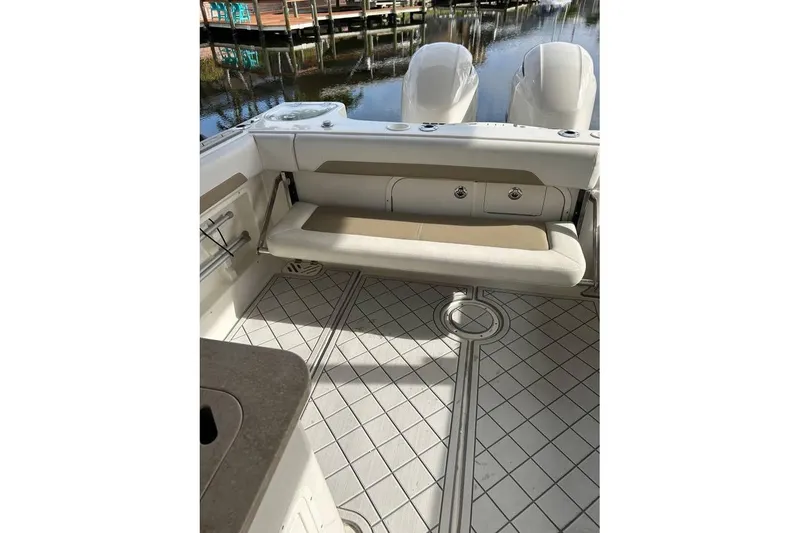 Slide: The Image of 2016 Sailfish 275 DC boat interior with seating and dual engines. - 8